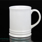 Small white ceramic beer mug with a straight body