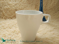 White horn shaped ceramic mugs with a finger ring